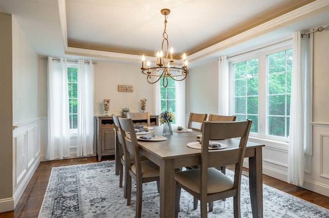 35 Fletcher Ln, Hollis, NH 03049 - dining space with a chandelier, a decorative wall, a raised ceiling, dark wood-type flooring, and a wainscoted wall