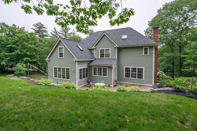 35 Fletcher Ln, Hollis, NH 03049 - back of property with a chimney, a lawn, and a shingled roof