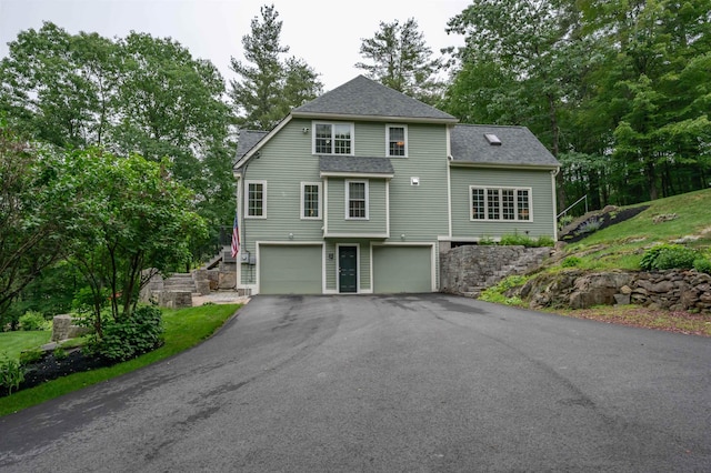 35 Fletcher Ln, Hollis, NH 03049 - view of front of property with an attached garage, driveway, a shingled roof, and view of wooded area
