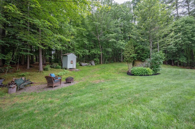 35 Fletcher Ln, Hollis, NH 03049 - view of green lawn with an outdoor fire pit and a storage unit