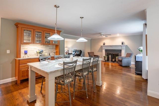 35 Fletcher Ln, Hollis, NH 03049 - kitchen featuring brown cabinetry, ceiling fan, decorative backsplash, dark wood-type flooring, and pendant lighting