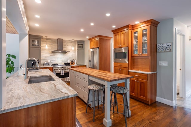 35 Fletcher Ln, Hollis, NH 03049 - kitchen with appliances with stainless steel finishes, wall chimney range hood, wooden counters, tasteful backsplash, and brown cabinets