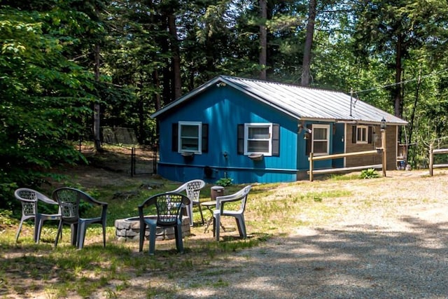 25 Singer Ln, Conway, NH 03813 - view of home's exterior featuring a fire pit and a metal roof