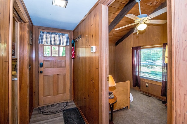 25 Singer Ln, Conway, NH 03813 - entryway featuring vaulted ceiling, wooden walls, ceiling fan, and carpet flooring