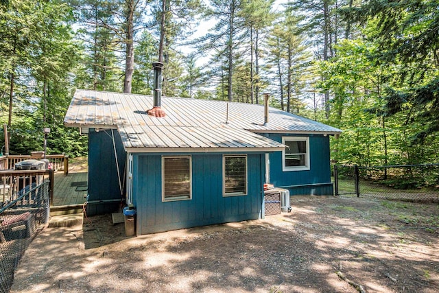 25 Singer Ln, Conway, NH 03813 - rear view of house featuring a deck, a metal roof, and view of wooded area