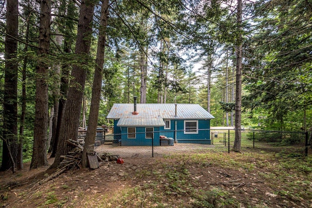 25 Singer Ln, Conway, NH 03813 - back of property featuring a metal roof and a wooded view