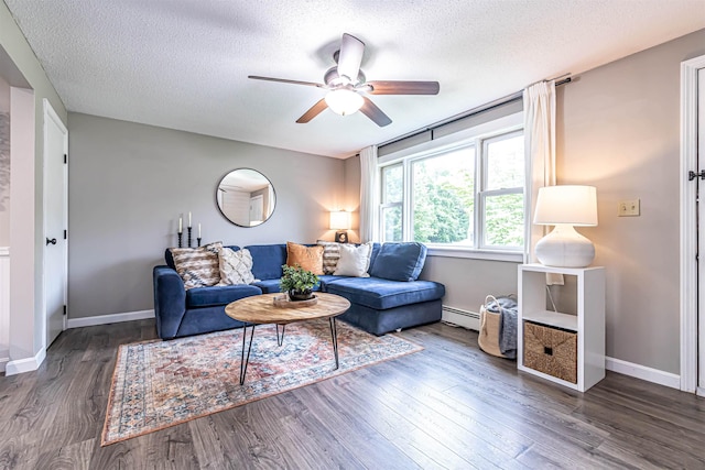 71/2 Olesen Rd, Derry, NH 03038 - living area featuring baseboard heating, ceiling fan, a textured ceiling, and wood finished floors