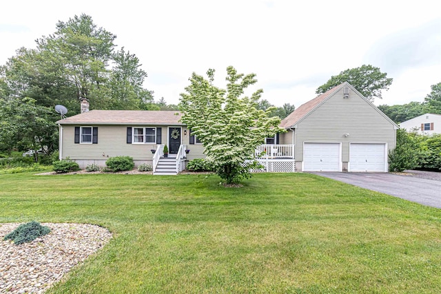 71/2 Olesen Rd, Derry, NH 03038 - view of front facade featuring driveway, a front yard, an attached garage, and a chimney