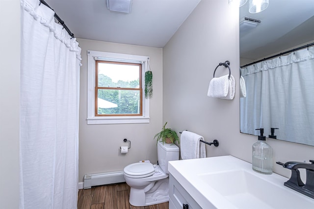 71/2 Olesen Rd, Derry, NH 03038 - full bath featuring a baseboard heating unit, wood finished floors, and vanity