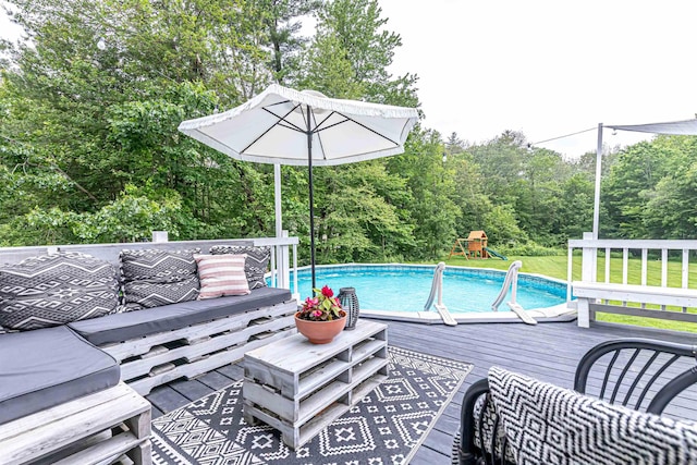 71/2 Olesen Rd, Derry, NH 03038 - outdoor pool featuring a wooden deck, a playground, and view of scattered trees