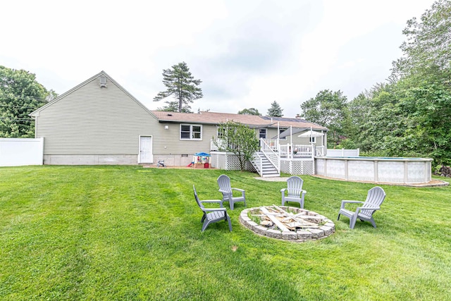 71/2 Olesen Rd, Derry, NH 03038 - back of property featuring a deck, a fire pit, a yard, an outdoor pool, and stairs