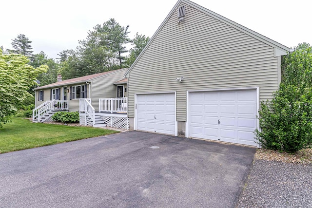71/2 Olesen Rd, Derry, NH 03038 - view of front of house with asphalt driveway, an attached garage, and a front lawn