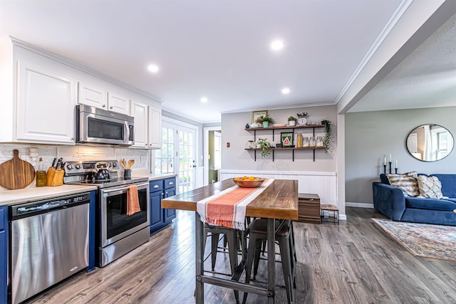 71/2 Olesen Rd, Derry, NH 03038 - kitchen with stainless steel appliances, blue cabinets, white cabinets, ornamental molding, and open shelves