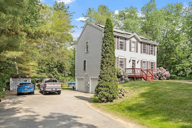 245 W River Rd, Hooksett, NH 03106 - colonial inspired home featuring a garage, a front lawn, asphalt driveway, and solar panels