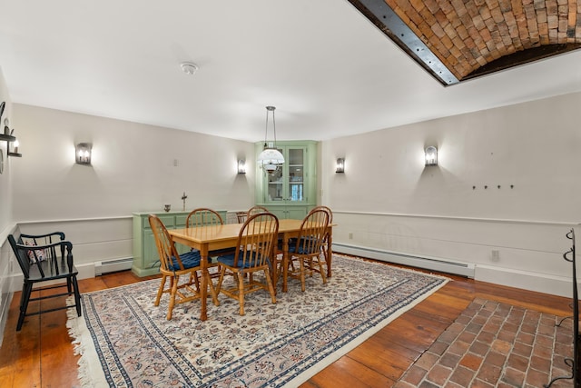 85 Dartmouth College Hwy Unit 204, Lyme, NH 03768 - dining space with baseboard heating, hardwood / wood-style flooring, and wainscoting