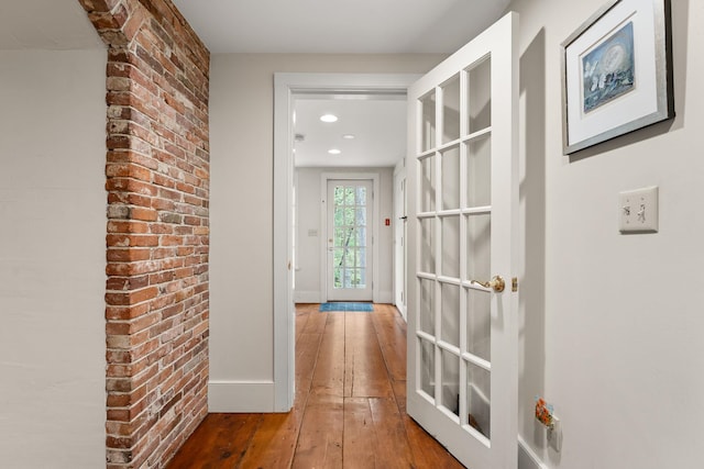85 Dartmouth College Hwy Unit 204, Lyme, NH 03768 - hall featuring hardwood / wood-style floors, recessed lighting, and brick wall