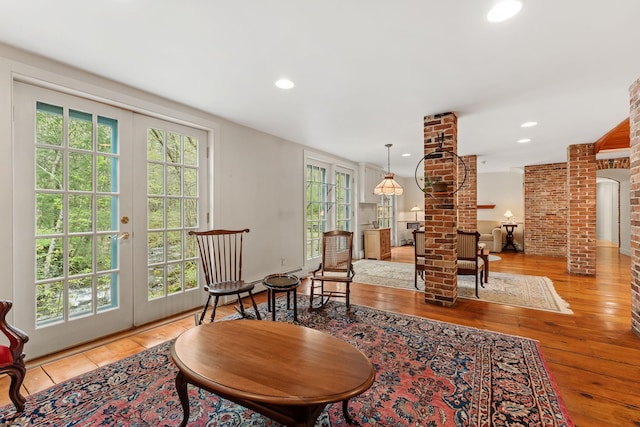 85 Dartmouth College Hwy Unit 204, Lyme, NH 03768 - living room with french doors, healthy amount of natural light, decorative columns, wood-type flooring, and recessed lighting