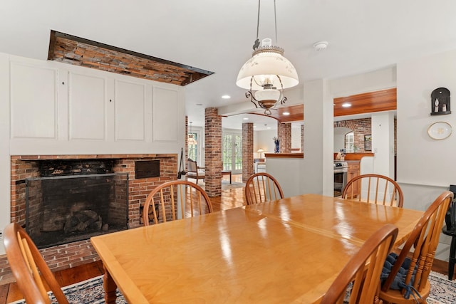 85 Dartmouth College Hwy Unit 204, Lyme, NH 03768 - dining space featuring decorative columns, a brick fireplace, recessed lighting, and wood finished floors