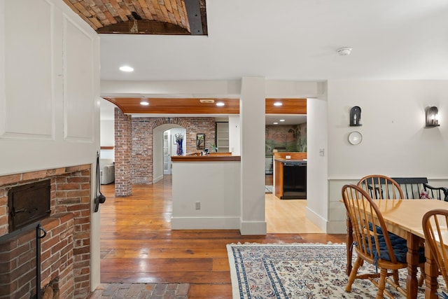85 Dartmouth College Hwy Unit 204, Lyme, NH 03768 - dining space with a fireplace, wood-type flooring, and arched walkways