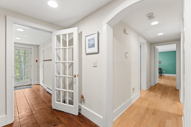 85 Dartmouth College Hwy Unit 204, Lyme, NH 03768 - hallway with light wood-style flooring, recessed lighting, arched walkways, and a baseboard radiator