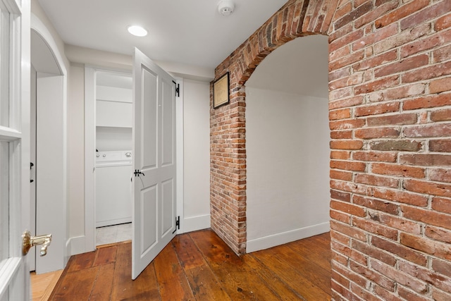 85 Dartmouth College Hwy Unit 204, Lyme, NH 03768 - corridor featuring washer / clothes dryer, hardwood / wood-style floors, brick wall, and arched walkways