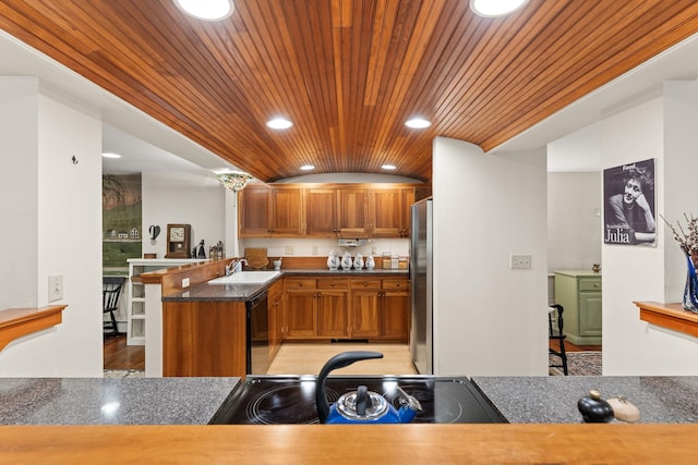 85 Dartmouth College Hwy Unit 204, Lyme, NH 03768 - kitchen with wooden ceiling, recessed lighting, brown cabinets, a peninsula, and freestanding refrigerator