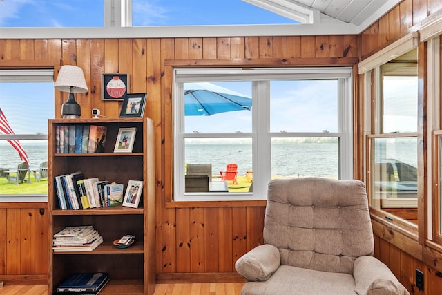 174 Kirk And Fitts Rd, Alburgh, VT 05440 - living area featuring a water view, wood finished floors, wooden walls, and vaulted ceiling