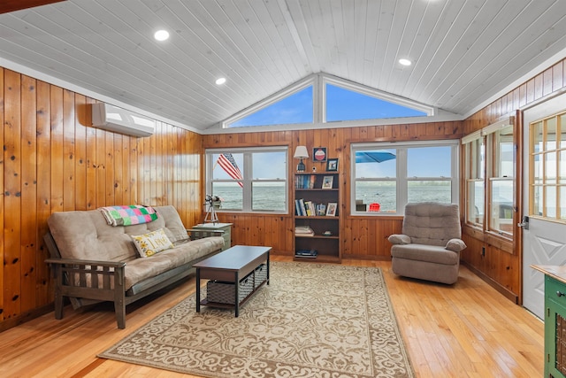 174 Kirk And Fitts Rd, Alburgh, VT 05440 - living area featuring lofted ceiling, light wood-style flooring, wooden walls, a water view, and plenty of natural light