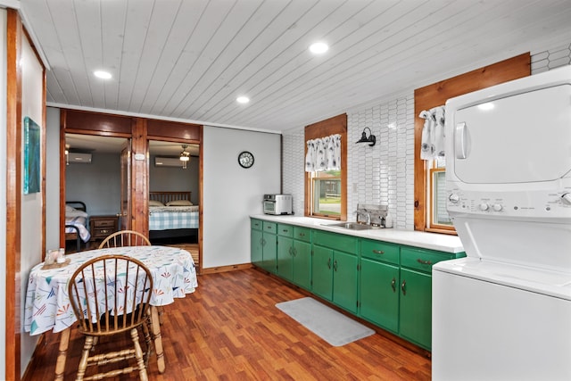 174 Kirk And Fitts Rd, Alburgh, VT 05440 - kitchen featuring estacked washer and dryer, wood finished floors, light countertops, green cabinets, and wood ceiling