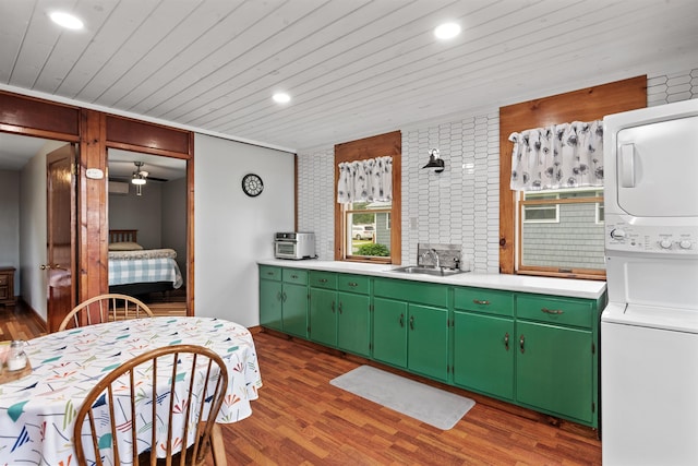 174 Kirk And Fitts Rd, Alburgh, VT 05440 - kitchen featuring stacked washing machine and dryer, wood finished floors, light countertops, recessed lighting, and wooden ceiling