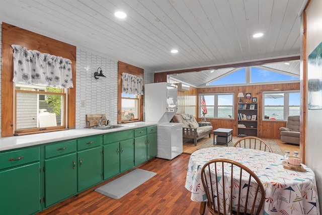 174 Kirk And Fitts Rd, Alburgh, VT 05440 - kitchen with estacked washer and dryer, wood ceiling, dark wood-style floors, wooden walls, and light countertops