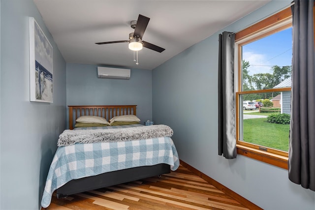 174 Kirk And Fitts Rd, Alburgh, VT 05440 - bedroom featuring a wall mounted air conditioner, wood finished floors, and ceiling fan