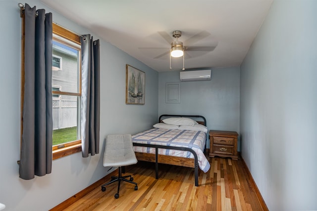 174 Kirk And Fitts Rd, Alburgh, VT 05440 - bedroom featuring a wall mounted AC, light wood finished floors, multiple windows, and a ceiling fan