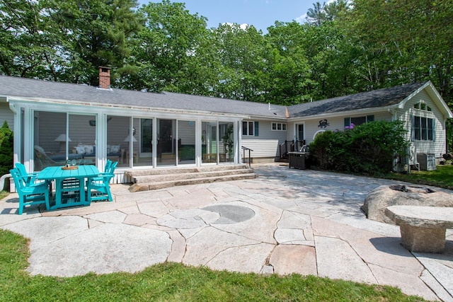496 Coles Hill Rd, Wells, ME 04090 - back of property with a patio, a chimney, entry steps, and a sunroom