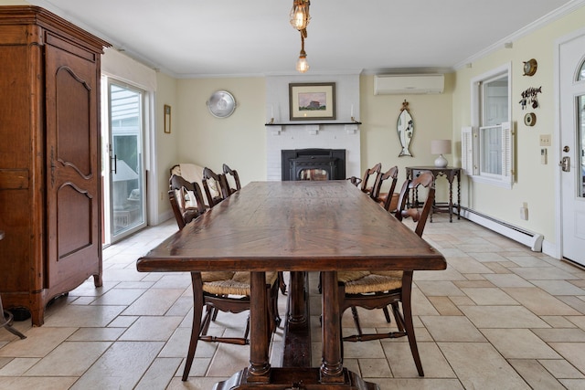 496 Coles Hill Rd, Wells, ME 04090 - dining space featuring a wall mounted AC, baseboard heating, a fireplace, stone tile floors, and crown molding