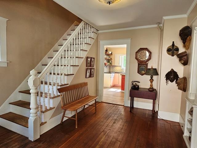 93 S Lincoln St, Keene, NH 03431 - staircase featuring wood-type flooring and crown molding