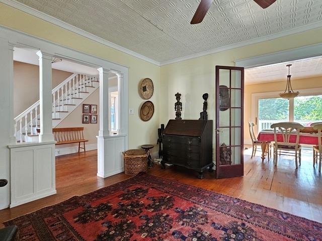 93 S Lincoln St, Keene, NH 03431 - sitting room featuring hardwood / wood-style floors, ceiling fan, an ornate ceiling, stairway, and ornate columns