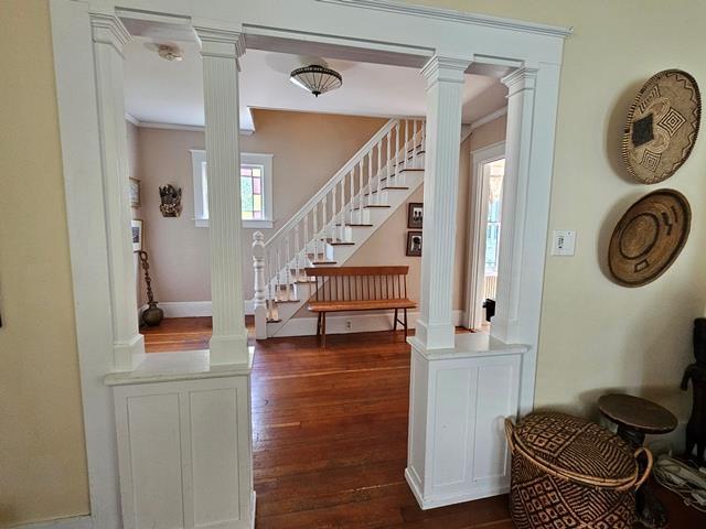 93 S Lincoln St, Keene, NH 03431 - stairway with ornate columns and wood finished floors