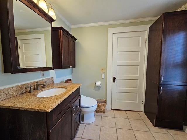 93 S Lincoln St, Keene, NH 03431 - bathroom featuring vanity, tile patterned flooring, and ornamental molding
