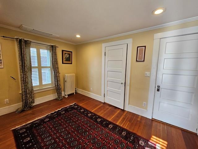 93 S Lincoln St, Keene, NH 03431 - entryway with radiator heating unit, wood finished floors, ornamental molding, and recessed lighting