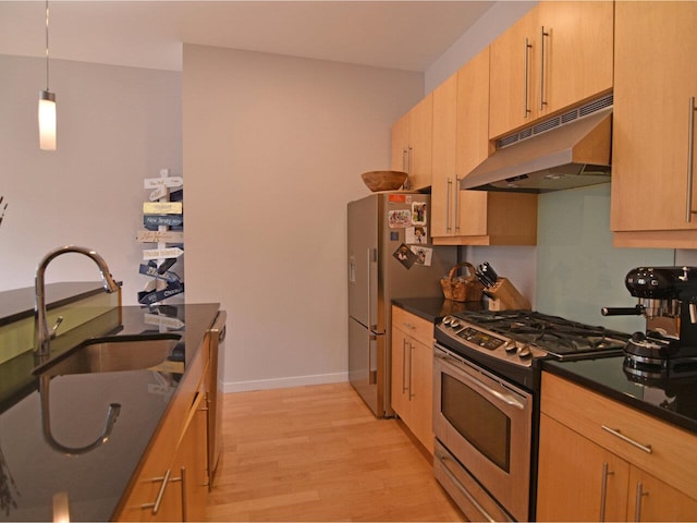 161 St Paul St Unit 202, Burlington, VT 05401 - kitchen featuring under cabinet range hood, stainless steel appliances, light wood finished floors, hanging light fixtures, and light brown cabinets