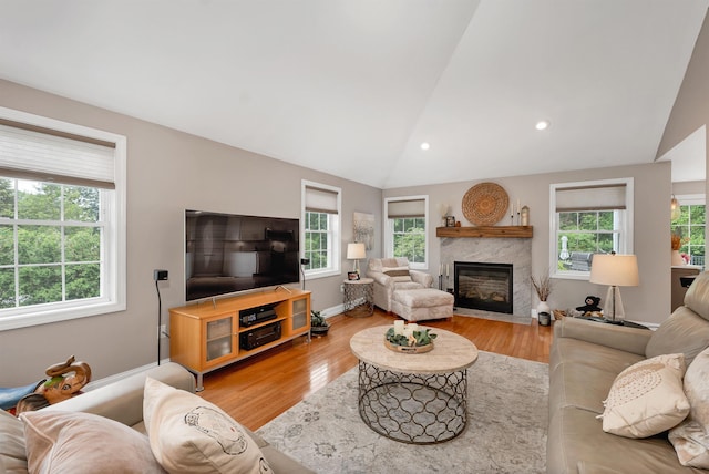 12 Julia Dr, Hooksett, NH 03106 - living area featuring vaulted ceiling, plenty of natural light, light wood finished floors, a high end fireplace, and recessed lighting