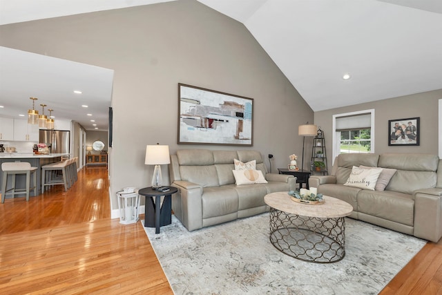 12 Julia Dr, Hooksett, NH 03106 - living area featuring light wood finished floors, high vaulted ceiling, recessed lighting, and a chandelier