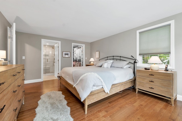 12 Julia Dr, Hooksett, NH 03106 - bedroom with wood finished floors, ensuite bath, a spacious closet, and a closet
