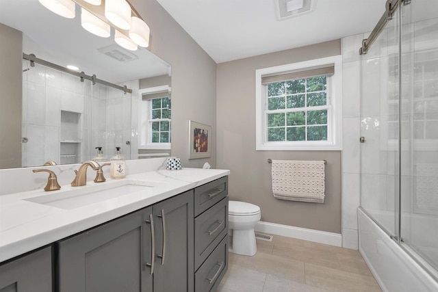 12 Julia Dr, Hooksett, NH 03106 - full bathroom featuring vanity, plenty of natural light, tile patterned flooring, and shower / bath combination with glass door