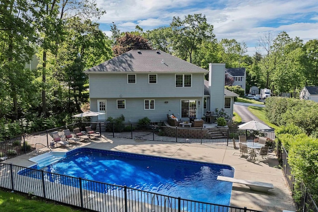 12 Julia Dr, Hooksett, NH 03106 - view of pool with a patio, a diving board, view of scattered trees, outdoor dining space, and an outdoor hangout area