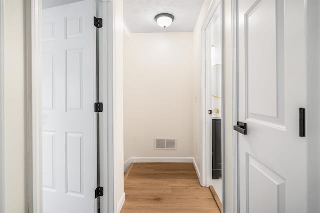 48 Eastmeadow Way, Manchester, NH 03109 - corridor with light wood-style floors and a textured ceiling