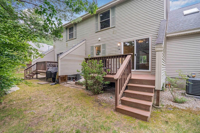 48 Eastmeadow Way, Manchester, NH 03109 - back of house with a deck, a lawn, stairway, and roof with shingles