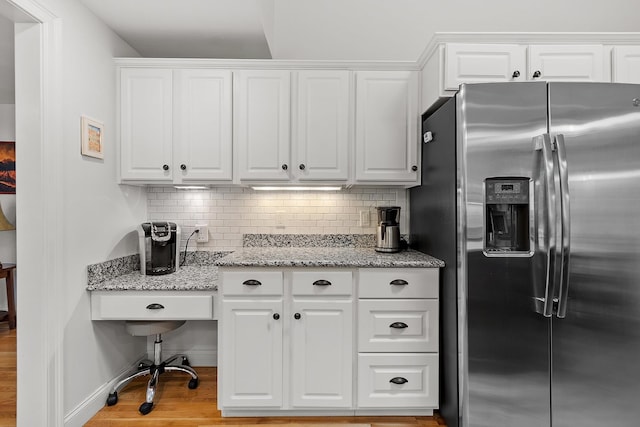 127 Hampton Mdws, Hampton, NH 03842 - kitchen featuring stainless steel refrigerator with ice dispenser, white cabinetry, backsplash, and light wood finished floors