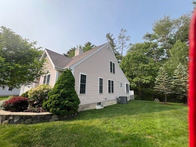127 Hampton Mdws, Hampton, NH 03842 - view of home's exterior with a chimney and a yard